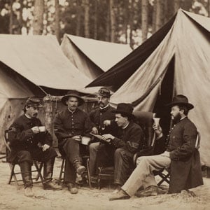 Civil War Scene: five soldiers sitting among tents