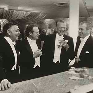 Kings of Hollywood (Clark Gable, Van Heflin, Gary Cooper, and James Stewart enjoy a joke at a New Year's Eve Party held at Romanoff's in Beverly Hills)